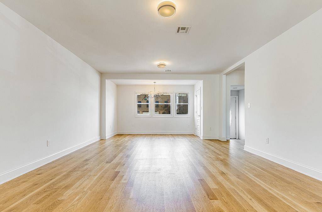 40 West 19th Street Bayonne, NJ 07002 - Photo 2 of 37 an empty room with wooden floor and windows