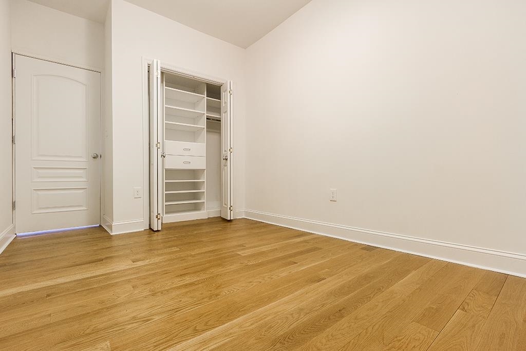 40 West 19th Street Bayonne, NJ 07002 - Photo 22 of 37 a view of an empty room with wooden floor