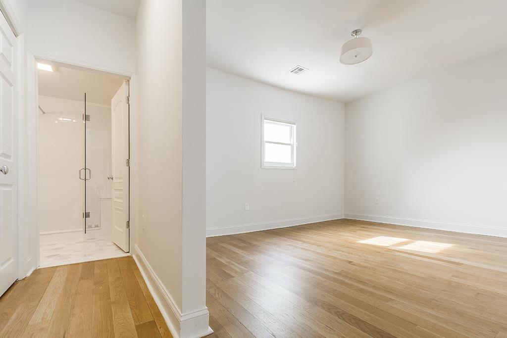 40 West 19th Street Bayonne, NJ 07002 - Photo 24 of 37 an empty room with wooden floor and windows