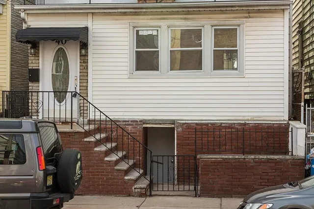 a front view of a house with a yard and a porch