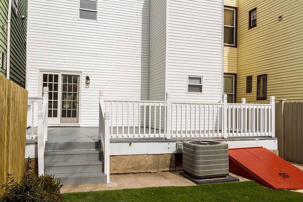40 West 19th Street Bayonne, NJ 07002 - Photo 32 of 37 a front view of a house with a yard and a porch