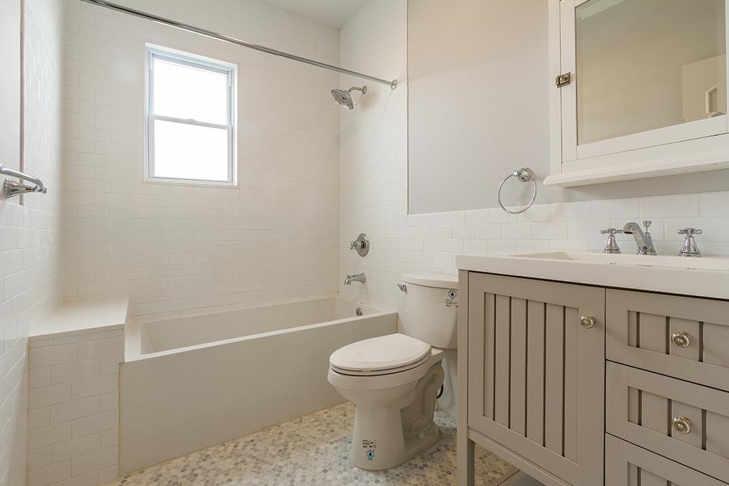 40 West 19th Street Bayonne, NJ 07002 - Photo 9 of 37 a bathroom with a sink a toilet and shower