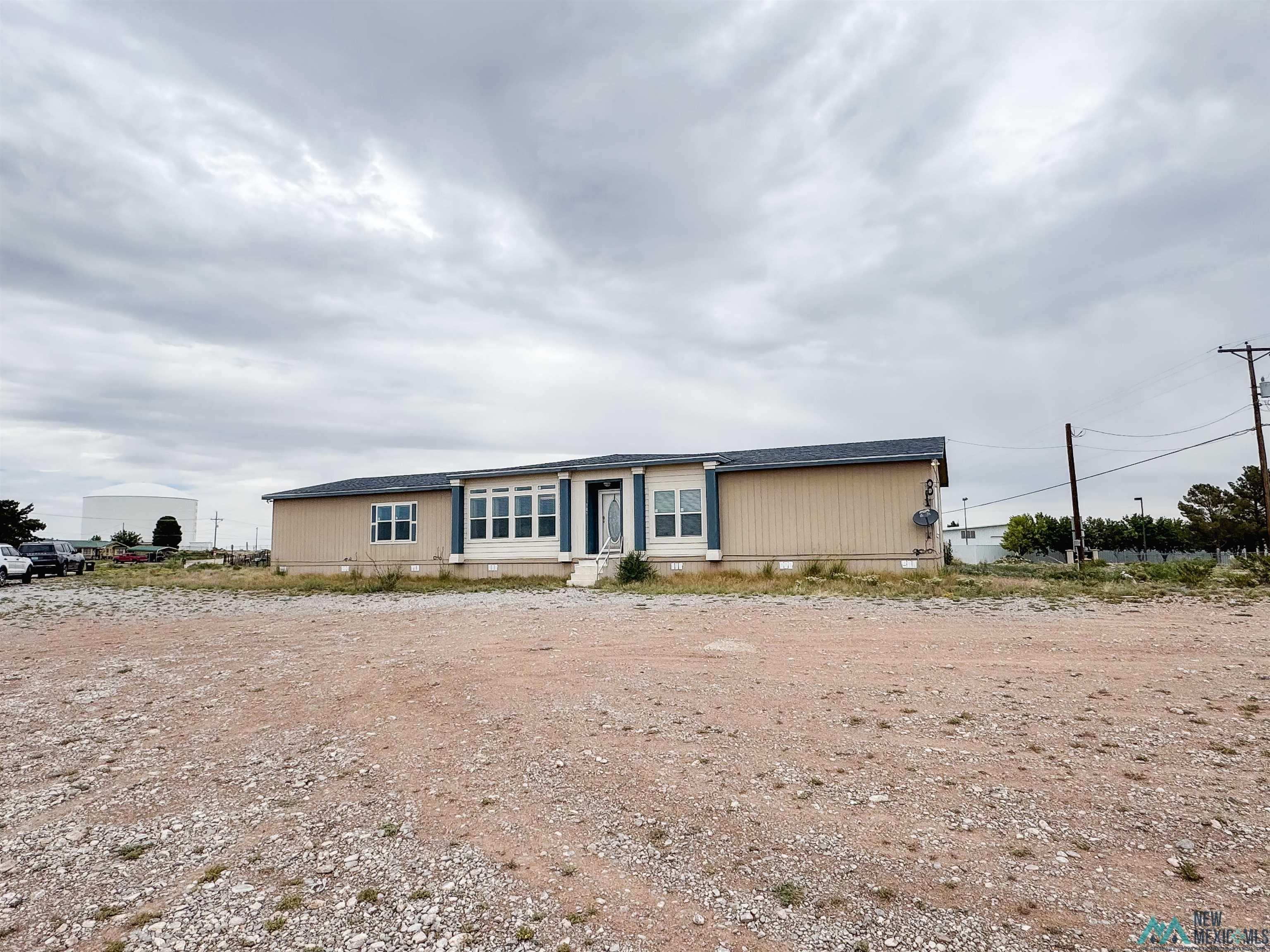 309 Crossbow Road Artesia, NM 88210 - Photo 30 of 31 Single-story residence featuring a beige exterior with blue accent trim
