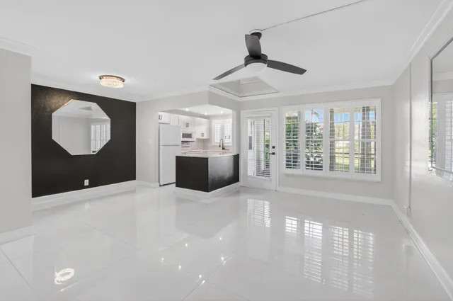 a view of a livingroom with a dishwasher cabinets and a large window