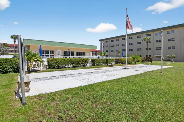 a view of a building with a yard