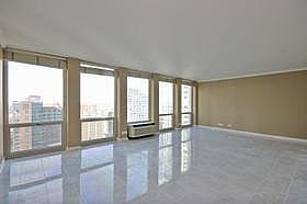 111 East Chestnut Street, Unit 31J Chicago, IL 60611 - Photo 4 of 9 an empty room with large windows