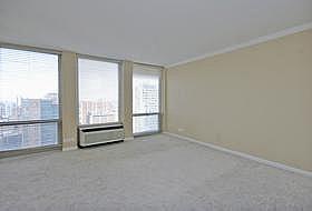 111 East Chestnut Street, Unit 31J Chicago, IL 60611 - Photo 7 of 9 an empty room with windows