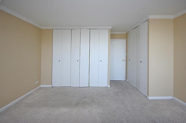 111 East Chestnut Street, Unit 31J Chicago, IL 60611 - Photo 8 of 9 a view of an empty room and closet area