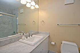 111 East Chestnut Street, Unit 31J Chicago, IL 60611 - Photo 9 of 9 a bathroom with a sink vanity granite toilet and a mirror