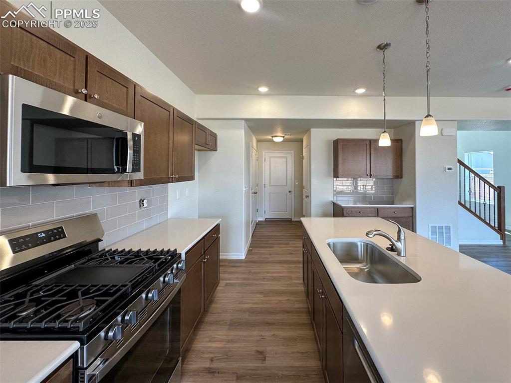 10820 Raylan Way Peyton, CO 80831 - Photo 11 of 35 a kitchen with sink stove and microwave