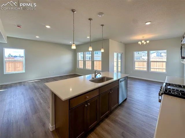 a kitchen with counter space and wooden floor