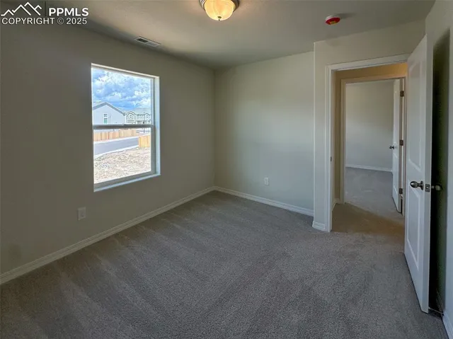 an empty room with windows and closet