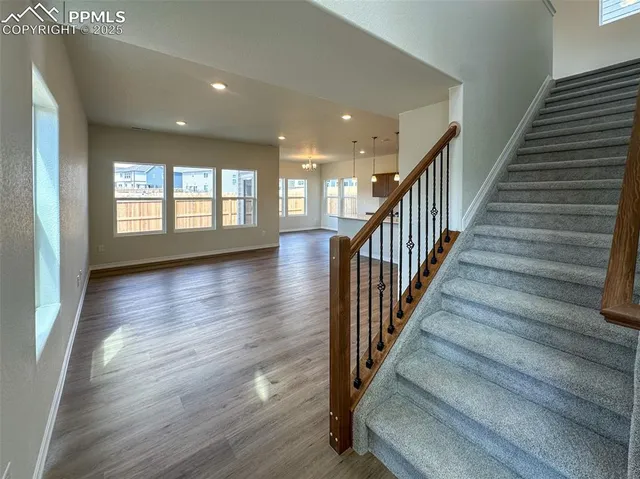 a view of an entryway with wooden floor
