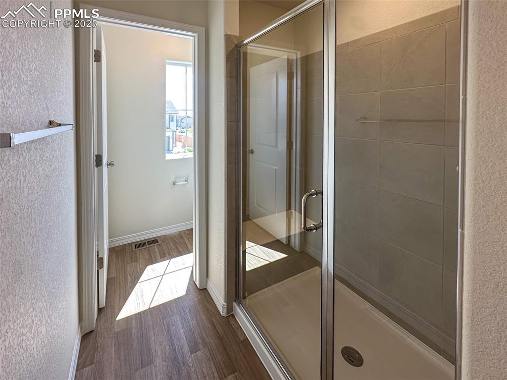 10820 Raylan Way Peyton, CO 80831 - Photo 33 of 35 a bathroom with a glass shower door