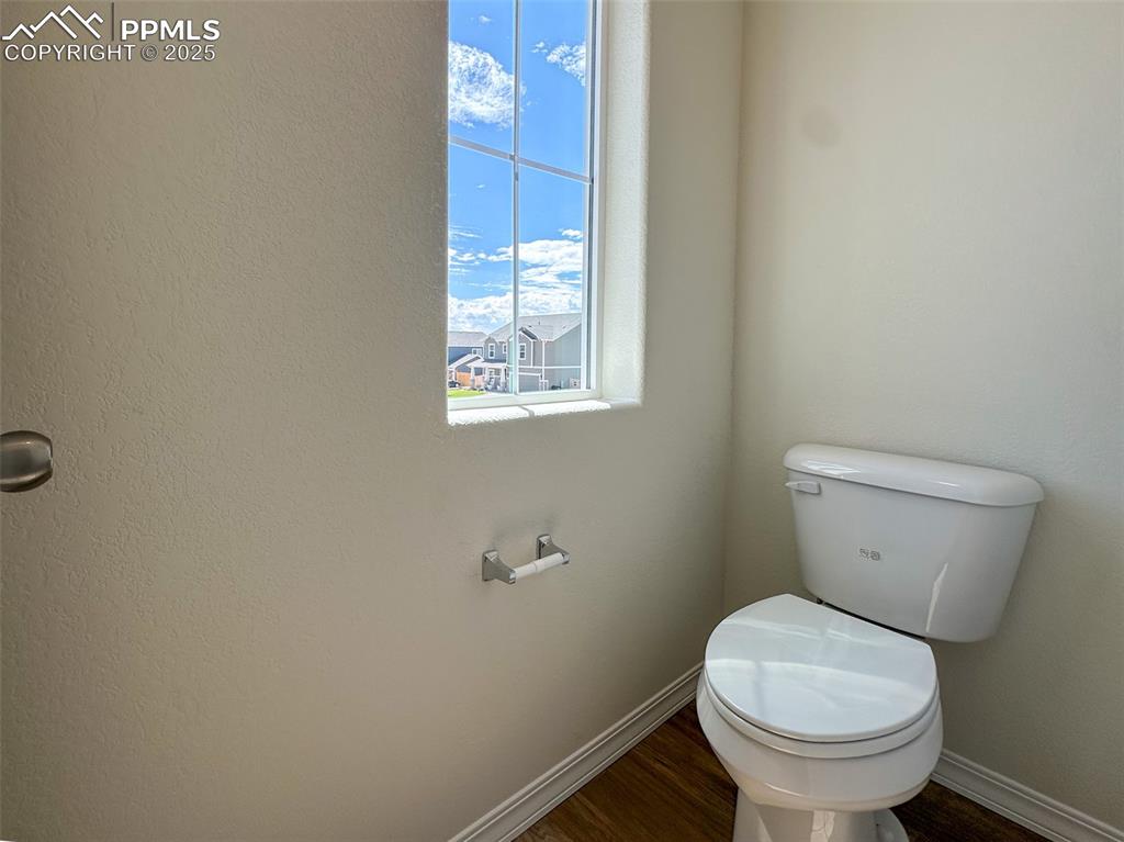10820 Raylan Way Peyton, CO 80831 - Photo 34 of 35 a toilet sitting in a bathroom next to a window
