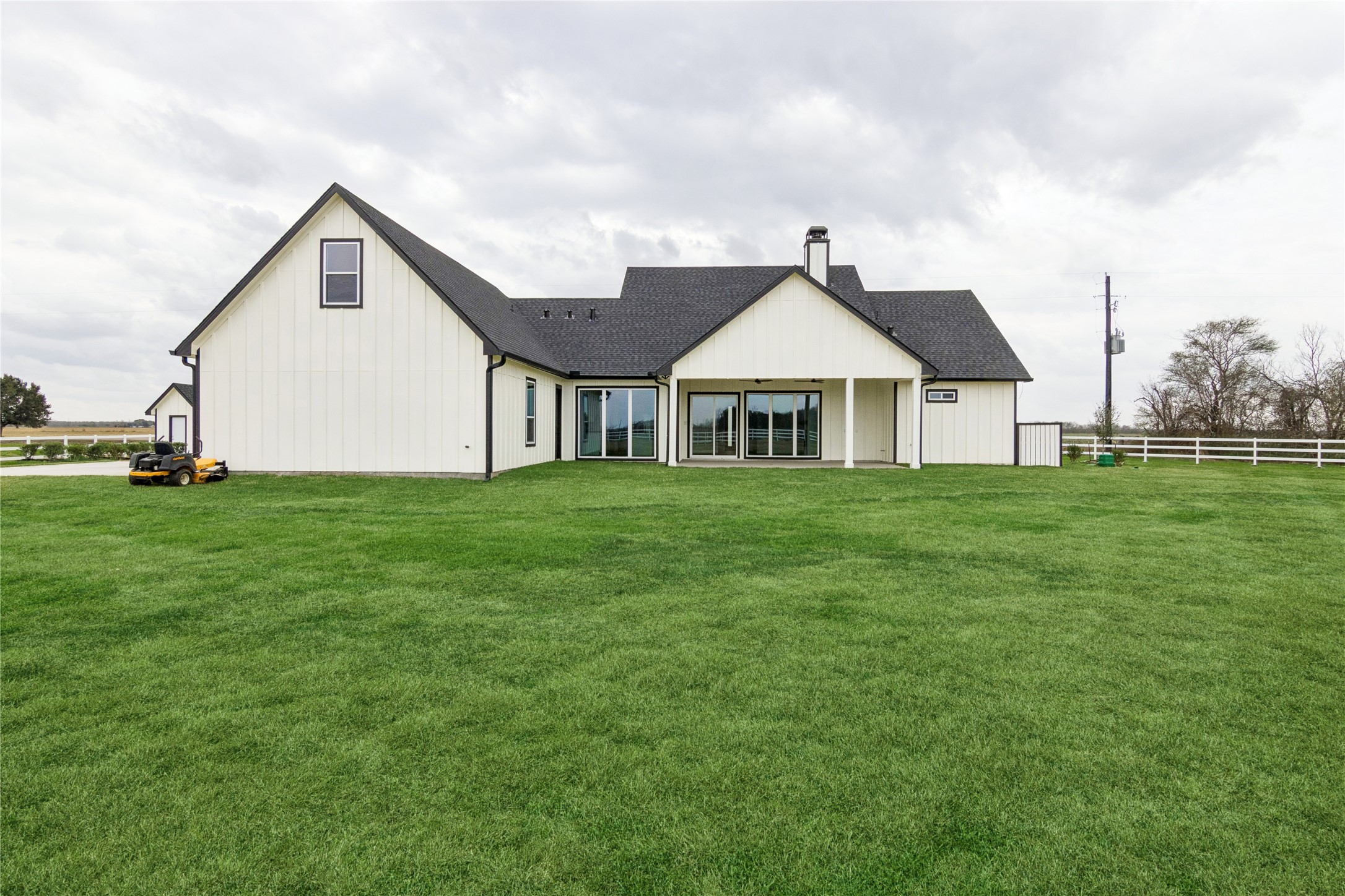 5766 Ward Bend Road Sealy, TX 77474 - Photo 40 of 45 a front view of a house with a yard and trees