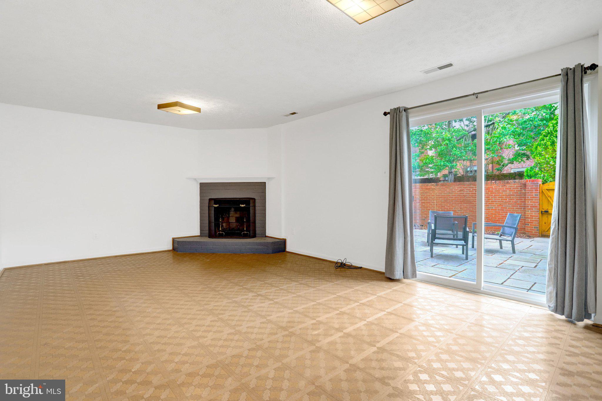 2225 North Tuckahoe Street Arlington, VA 22205 - Photo 22 of 37 a view of an empty room with a fireplace and a window