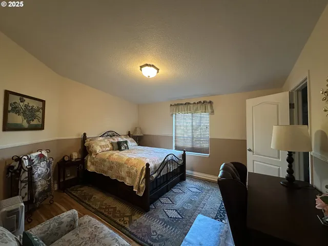 a bedroom with a bed lamp and a couch