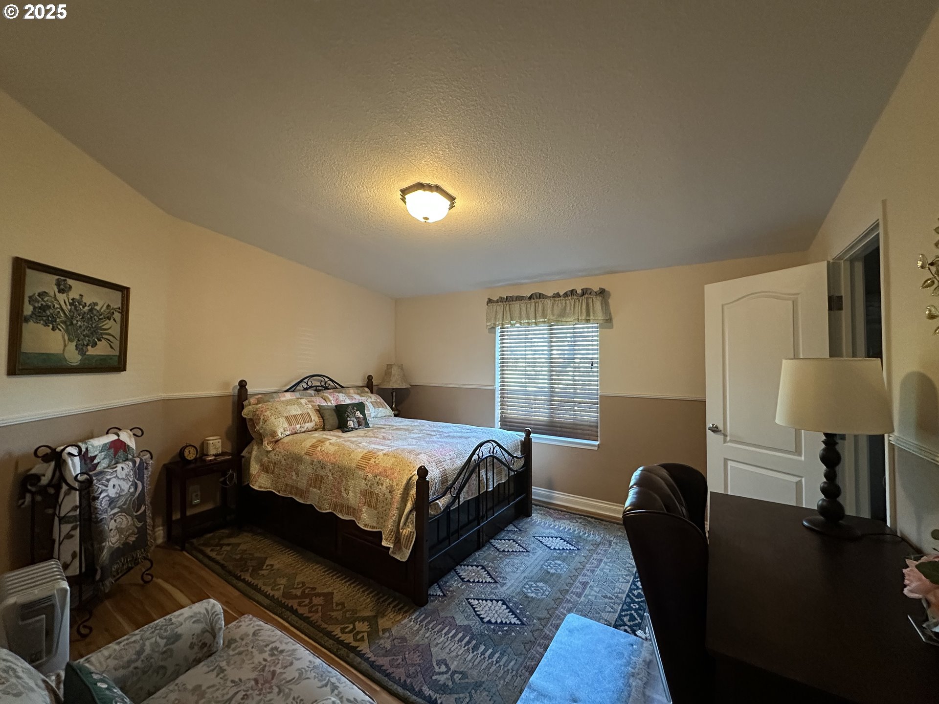 181 Vada Street Carson, WA 98610 - Photo 13 of 30 a bedroom with a bed lamp and a couch