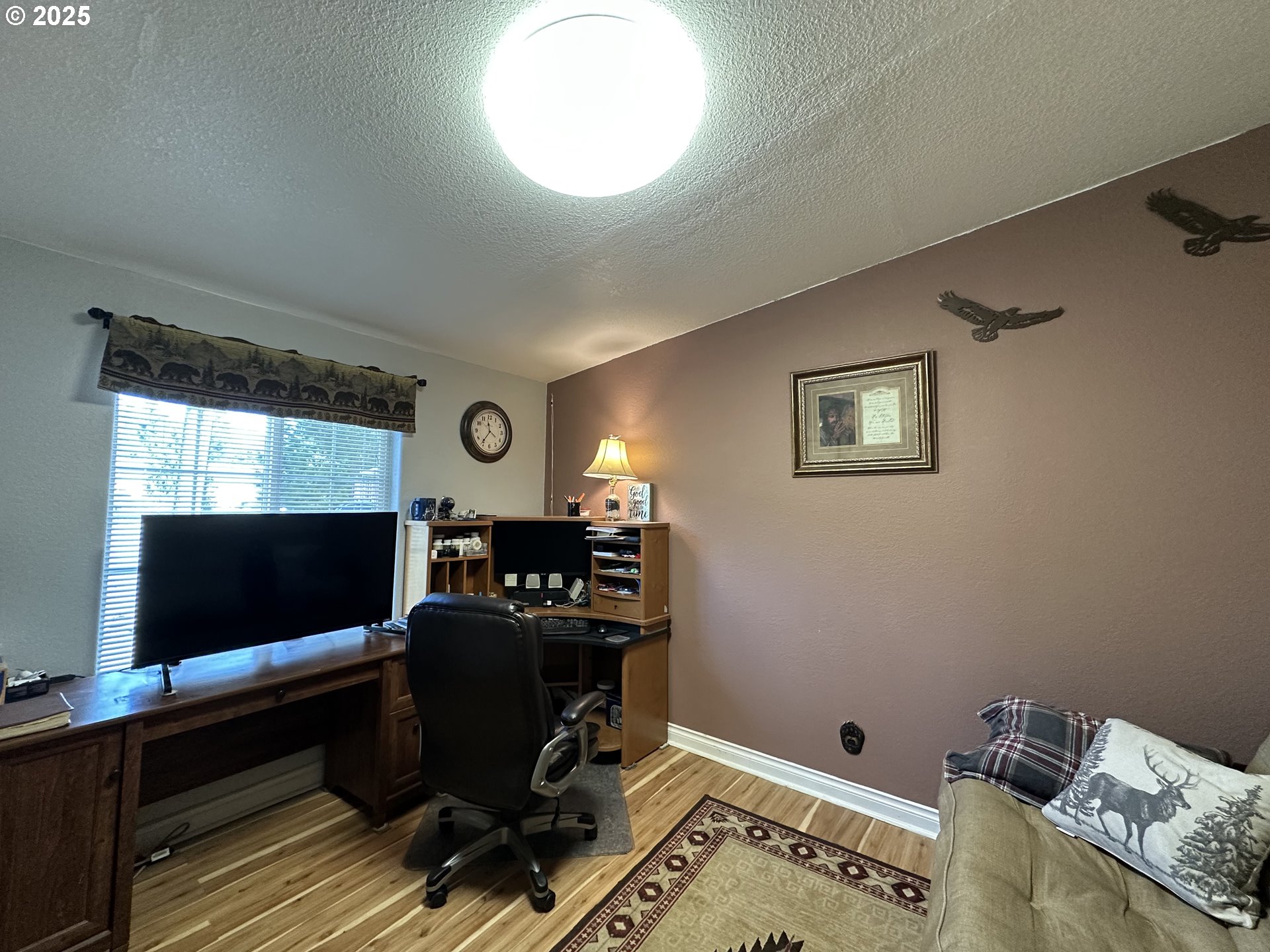 181 Vada Street Carson, WA 98610 - Photo 17 of 30 a view of a workspace with furniture and a flat screen tv