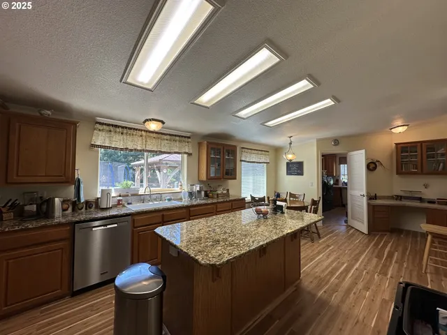 a kitchen with granite countertop lots of counter top space and stainless steel appliances