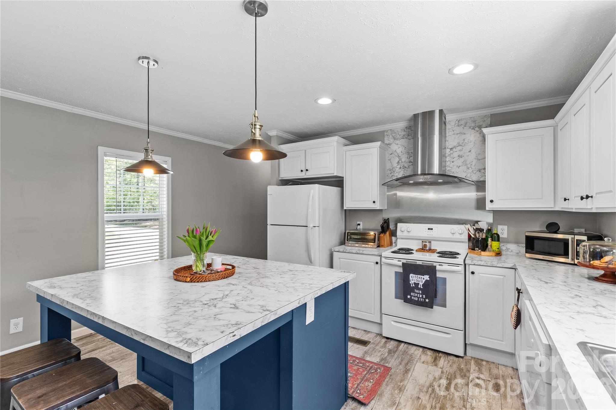 3041 Dr Nichols Road York, SC 29745 - Photo 10 of 26 a kitchen with stainless steel appliances granite countertop a sink a stove a dining table and chairs