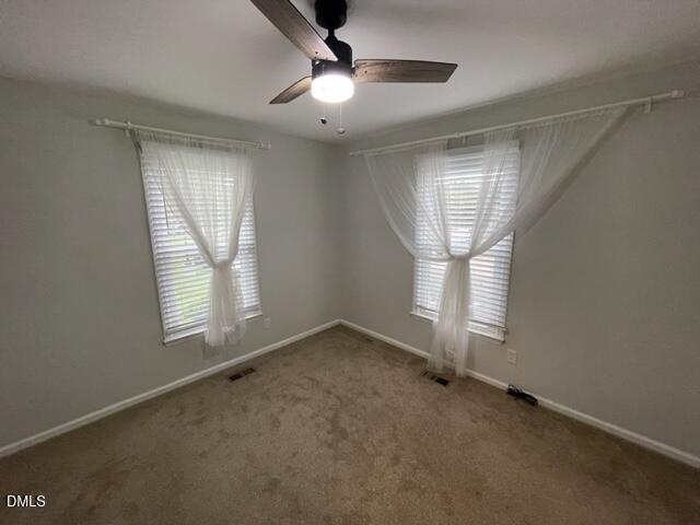 4804 Hoyle Drive, Unit A Raleigh, NC 27604 - Photo 16 of 19 an empty room with windows and fan