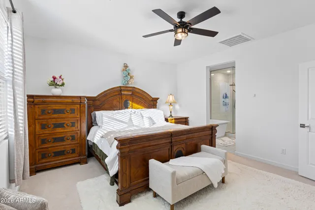 a spacious bathroom with a double vanity sink a mirror and a bathtub