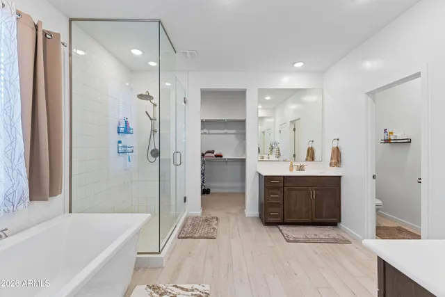 a bathroom with a double vanity sink a mirror and shower