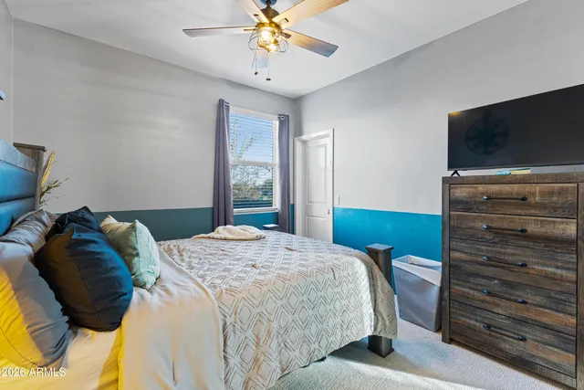 a bedroom with two beds and a chandelier