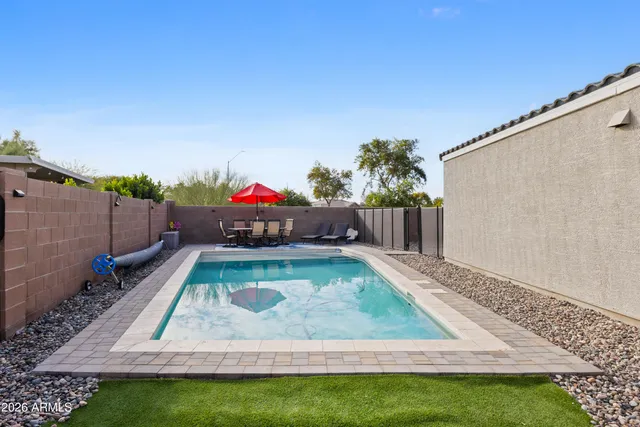 an aerial view of a city with lots of residential buildings ocean and mountain view in back