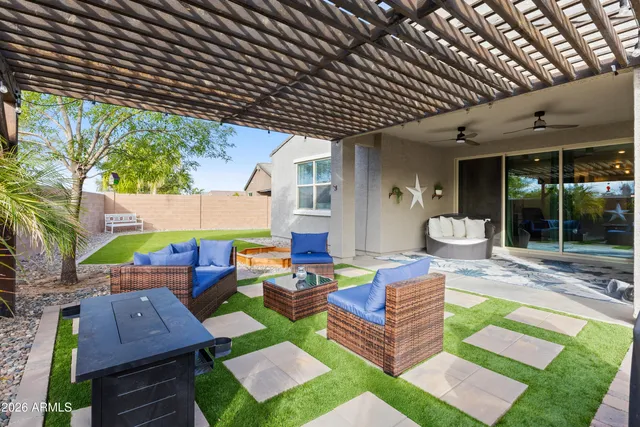 a front view of a house with a yard and potted plants
