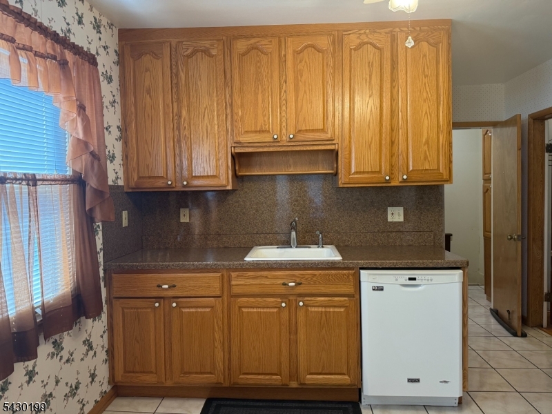 72 Baldwin Place, Unit 2 Bloomfield, NJ 07003 - Photo 2 of 24 a kitchen with granite countertop cabinets and a sink with wooden floor