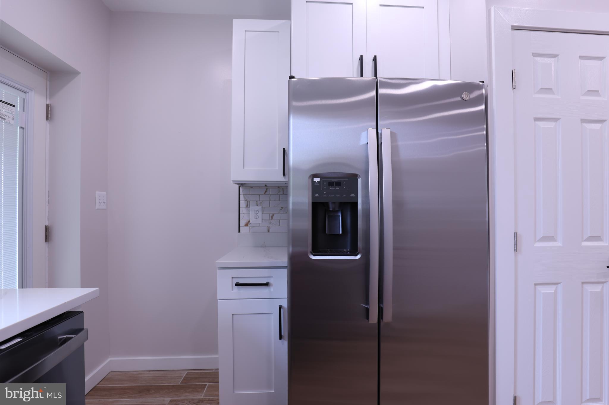 2039 Rosedale Street Northeast Washington, DC 20002 - Photo 5 of 18 a kitchen with a refrigerator and cabinets