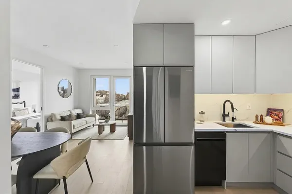 a kitchen with refrigerator and cabinets