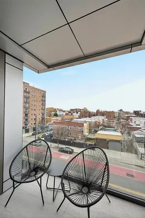 a view of a balcony with furniture