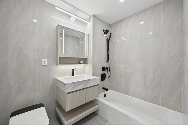 a bathroom with a sink toilet and shower