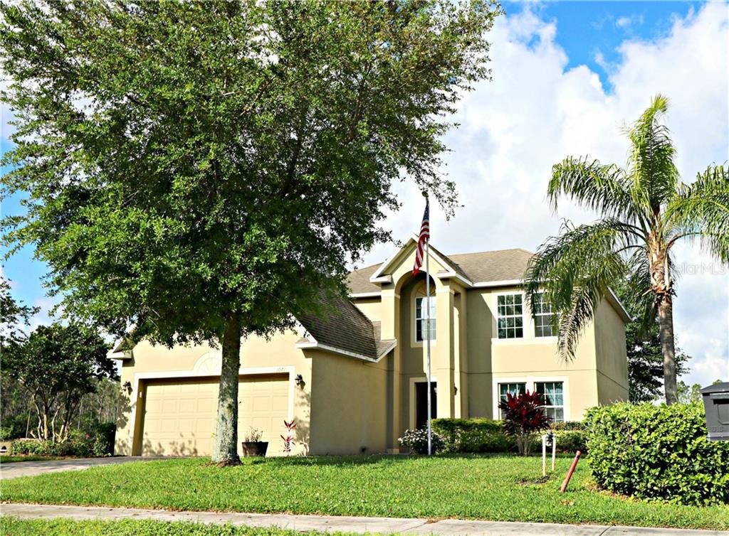 1071 Roberta Road Lake Wales, FL 33853 - Photo 1 of 1 a front view of a house with a garden and trees