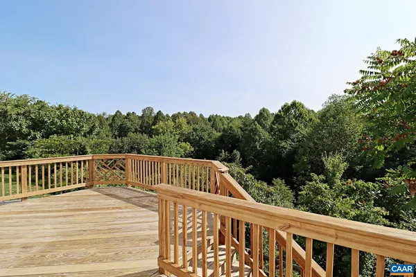 a view of balcony with wooden floor and fence