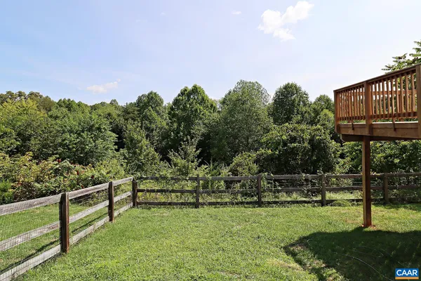 a view of yard with grass and trees