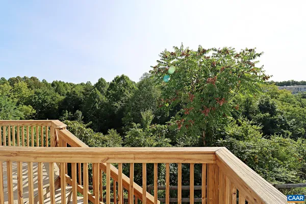 a view of a wooden fence and trees in the background