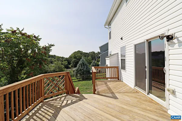 a view of balcony with wooden floor and fence