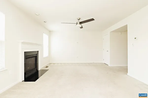 a view of a room with a ceiling fan