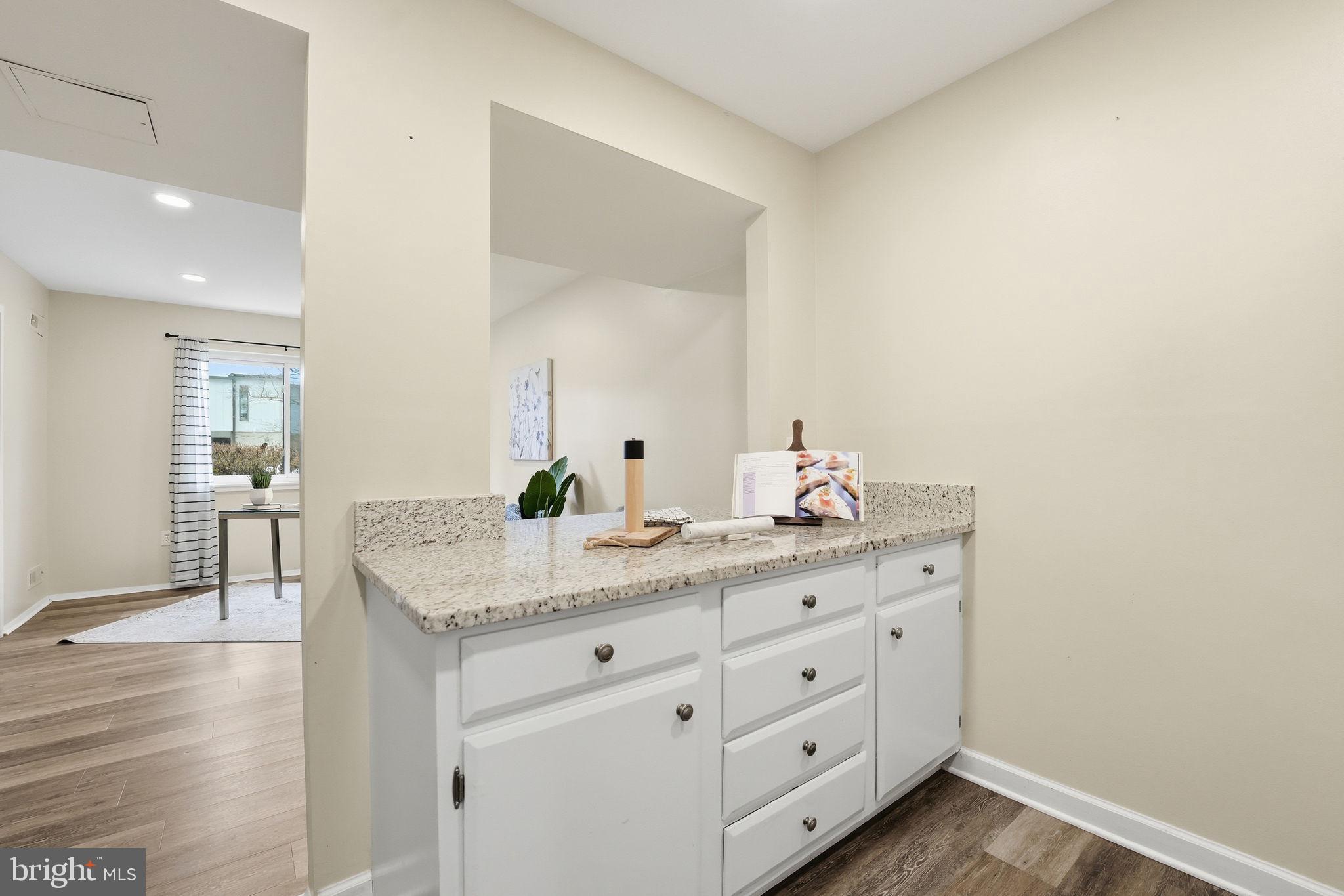 1735 Ivy Oak Square, Unit 7 Reston, VA 20190 - Photo 18 of 37 Kitchen Island iooking into multi use room