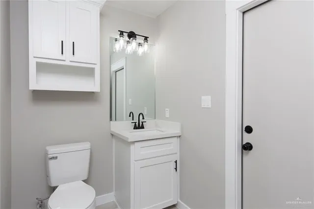 a view of an empty room with a window and a bathroom
