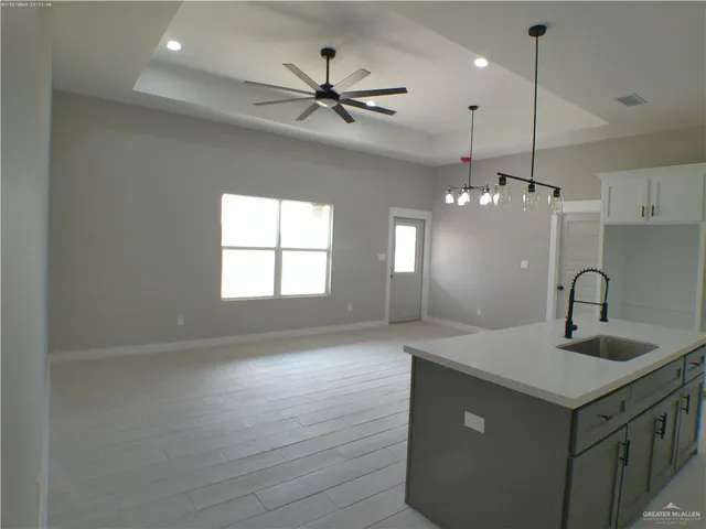 a view of cabinets and utility room with closet
