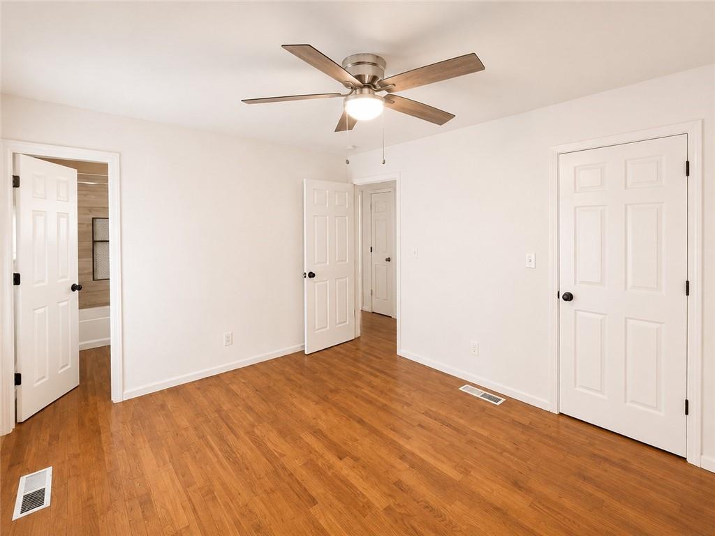 1929 Wee Kirk Road Southeast Atlanta, GA 30316 - Photo 15 of 22 an empty room with wooden floor and ceiling fan
