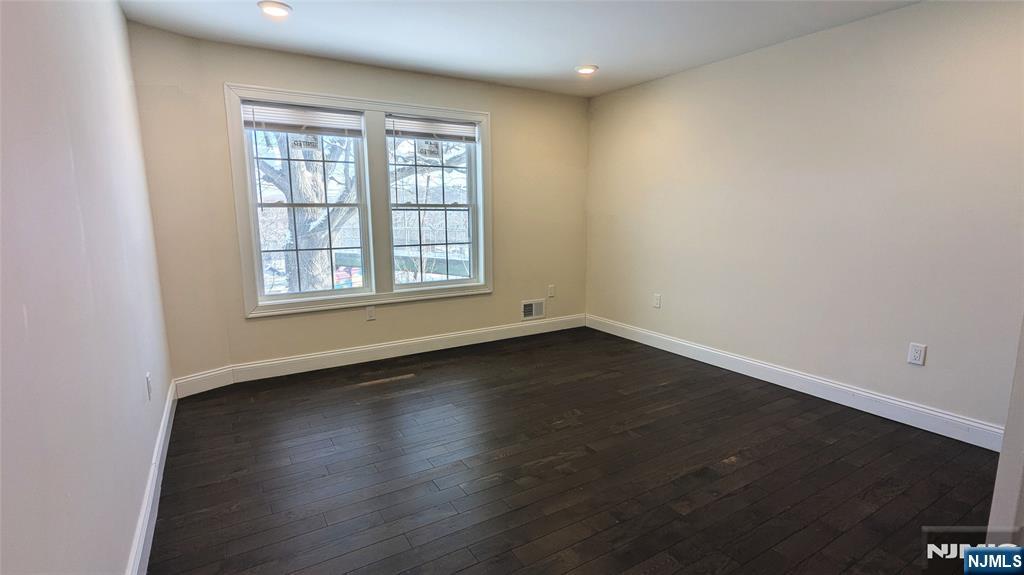 7 Maple Street, Unit 1 Bloomfield, NJ 07003 - Photo 13 of 19 an empty room with wooden floor and windows