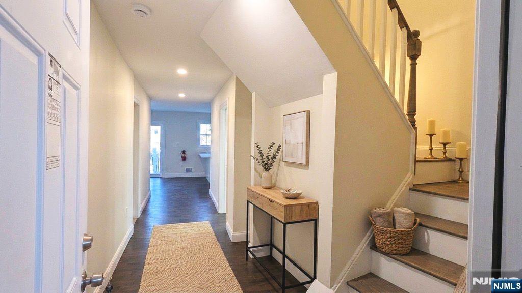 7 Maple Street, Unit 1 Bloomfield, NJ 07003 - Photo 2 of 19 a view of a hallway with wooden floor and windows