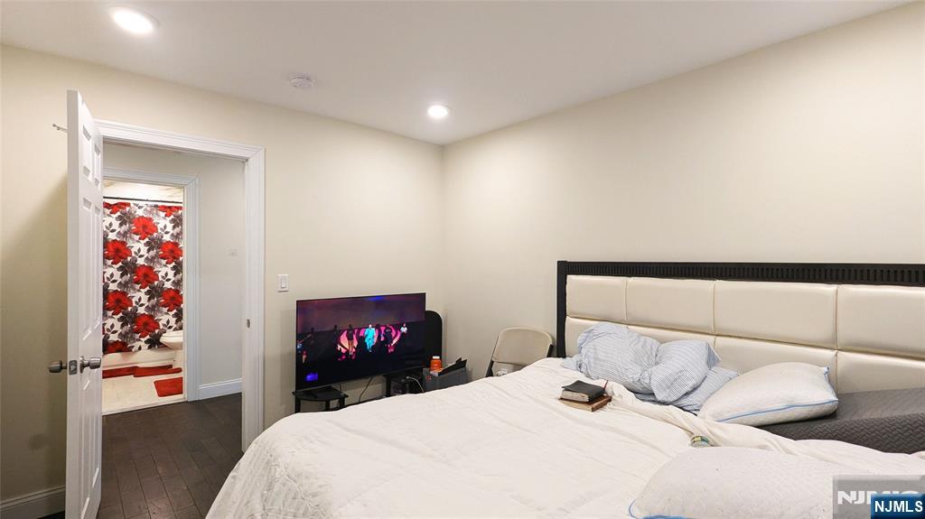 7 Maple Street, Unit 1 Bloomfield, NJ 07003 - Photo 5 of 19 a bedroom with a bed and a painting on the wall